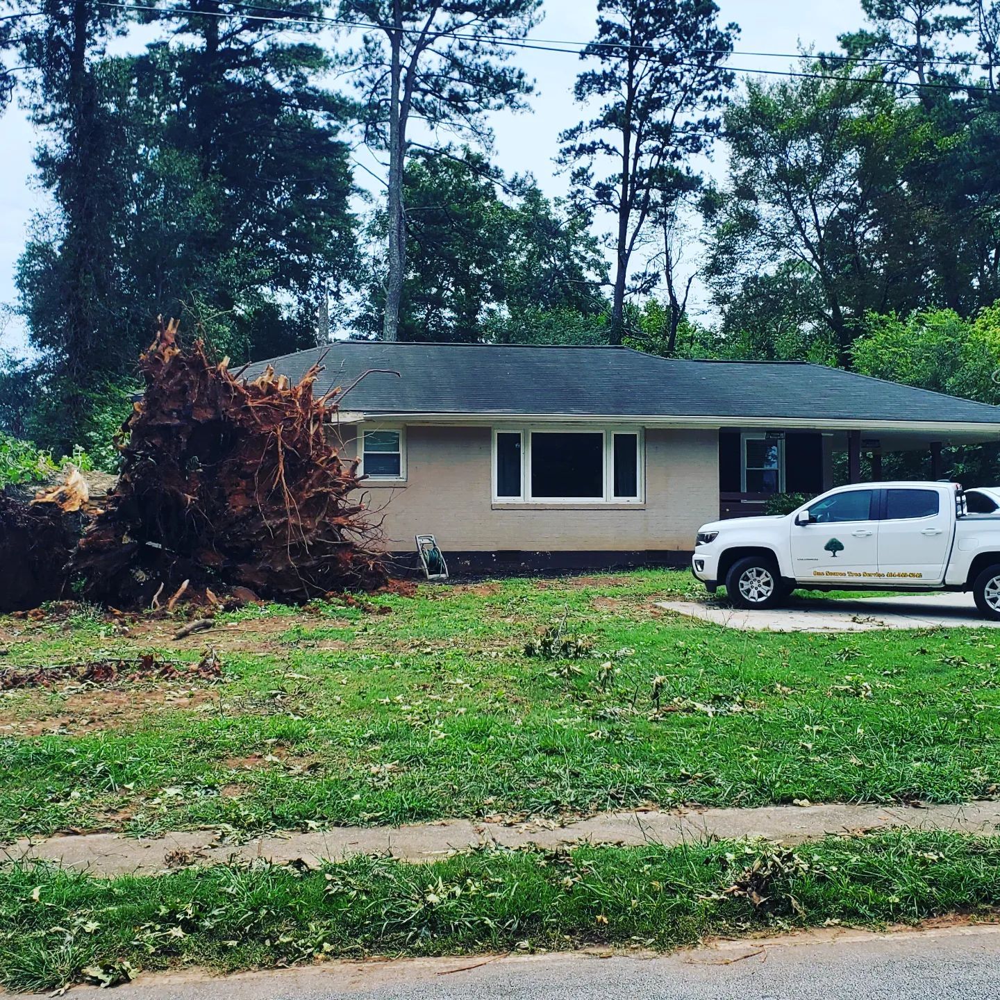 A white truck is parked in front of a house.