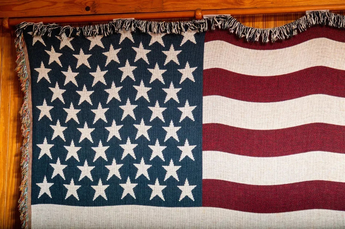 American flag textile, blue field of stars on the left, red and white stripes on the right.