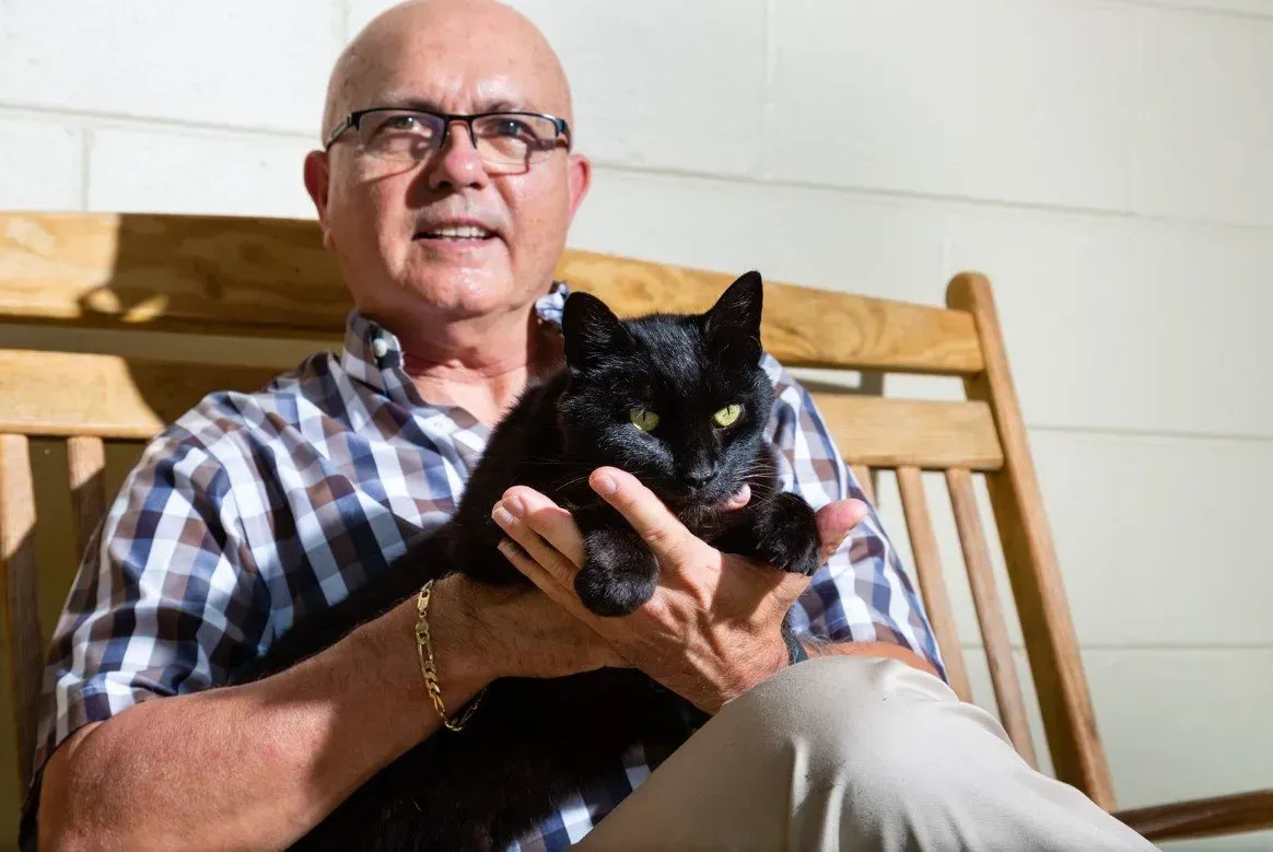 Frank with his black cat.