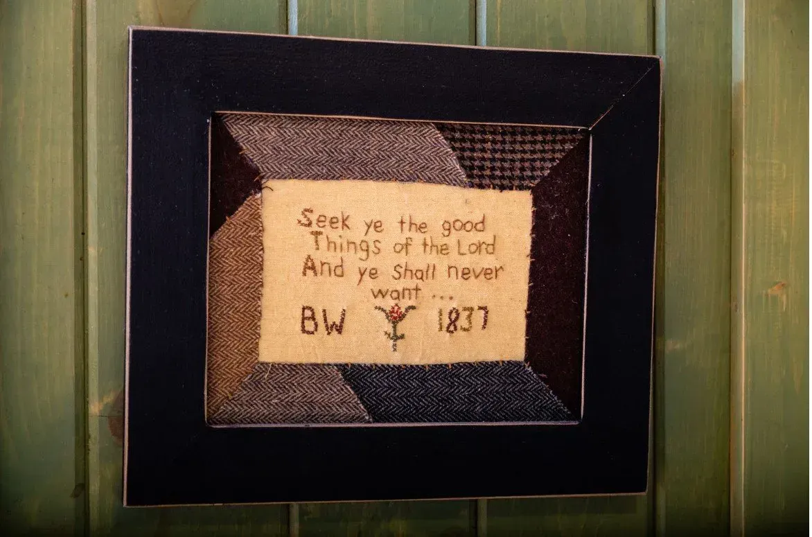 Framed textile art with quote: