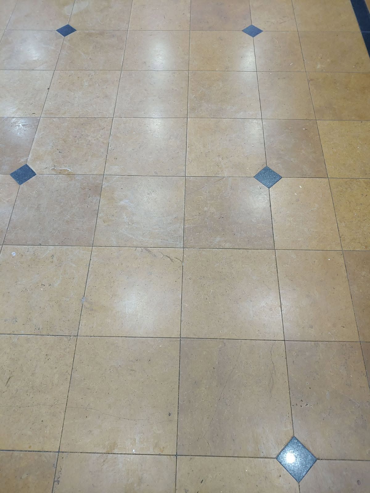 Beige tiled floor with dark blue diamond accents.