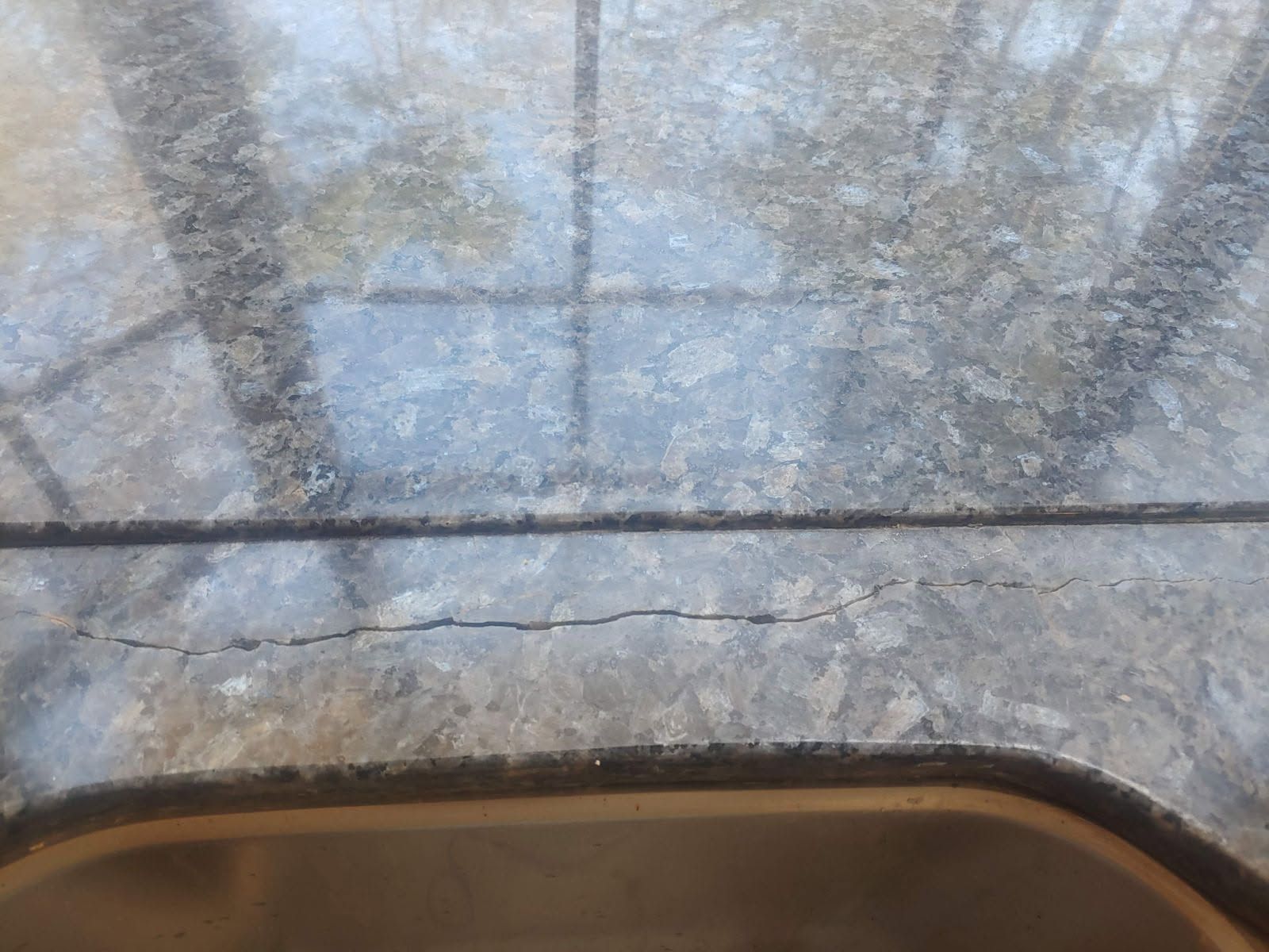 Cracked and weathered metal surface.