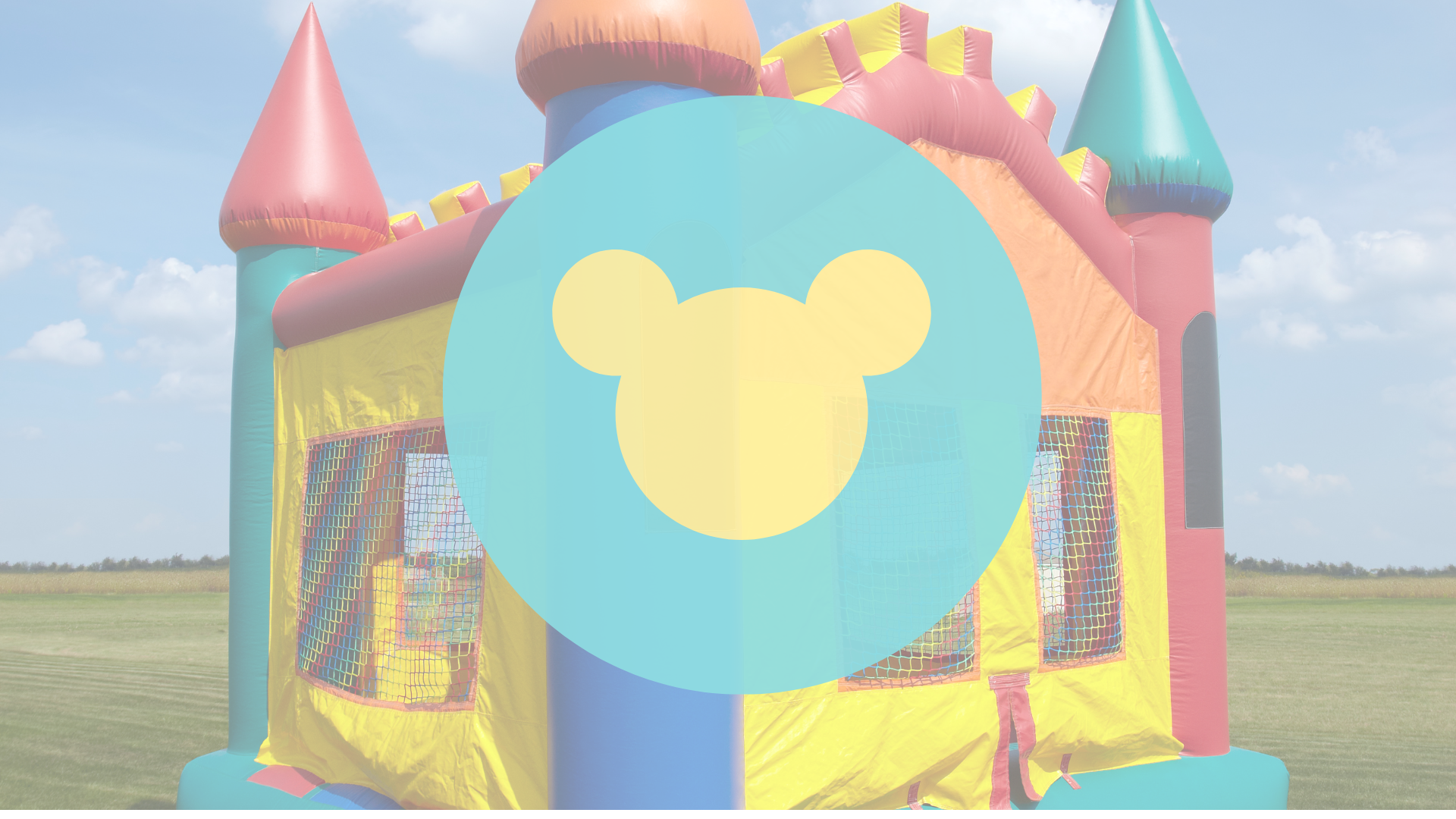 A colorful bouncy house with a mickey mouse head on it.