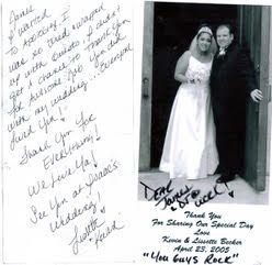 A bride and groom are posing for a picture with a thank you note.