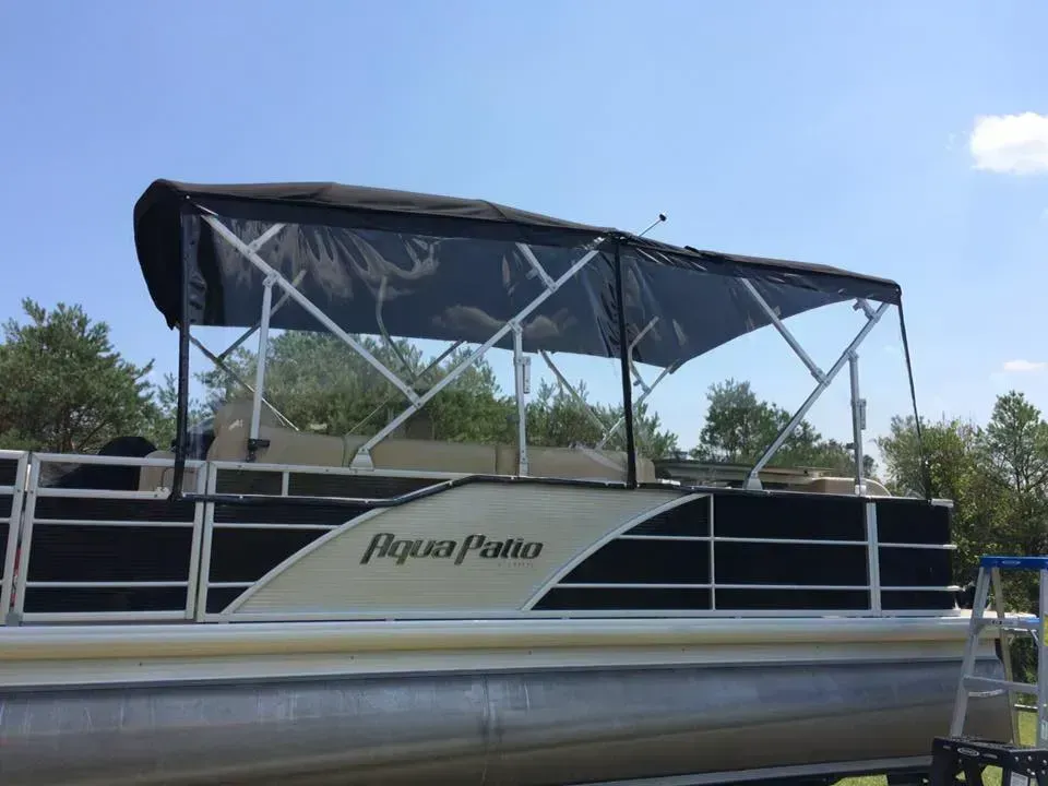 A pontoon boat with a canopy on top of it