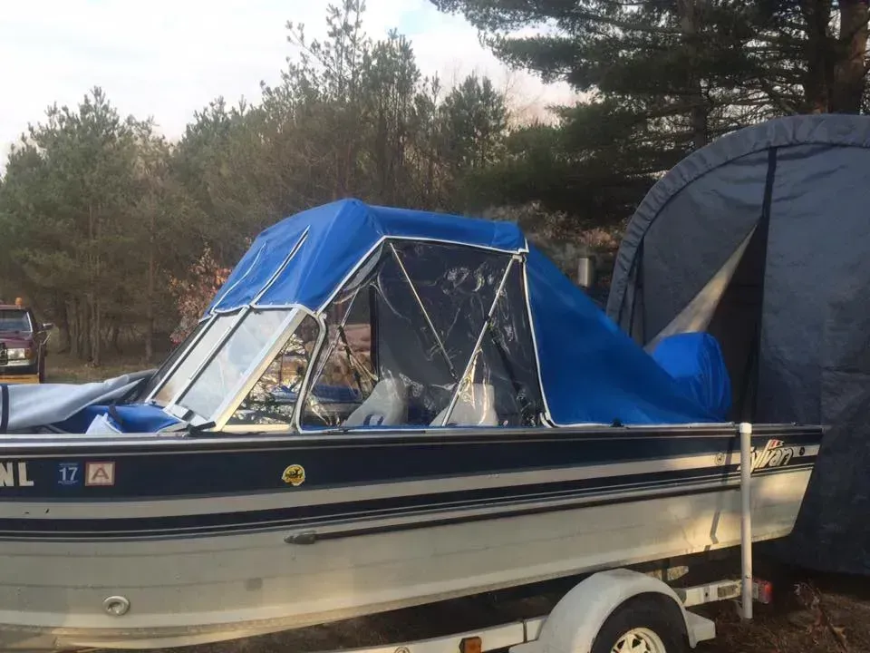 A boat on a trailer with a tent in the background