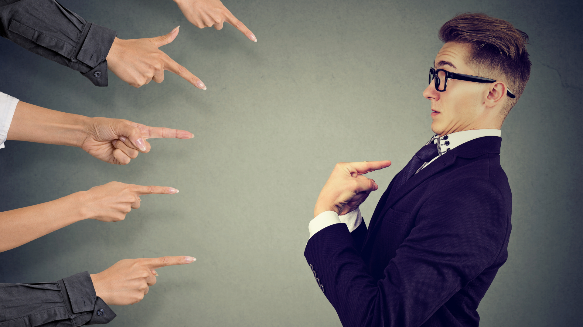 pointing fingers at a young professional
