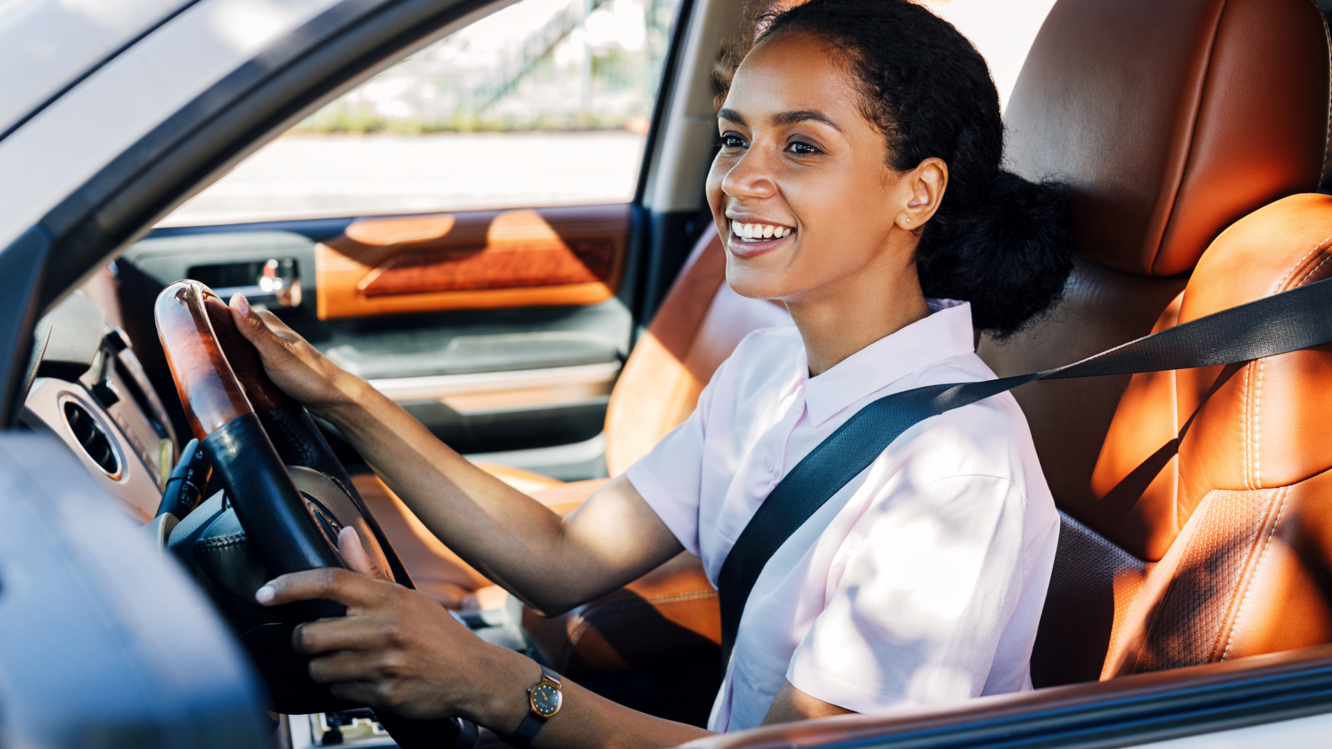 woman driving a luxury car with leather seats