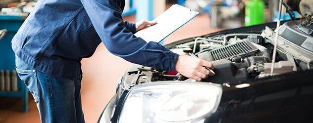Mechanic Completing Logbook Service — Mechanical & Smash Repairs in Bowen, QLD