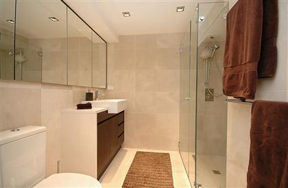 glass shower in warm bathroom