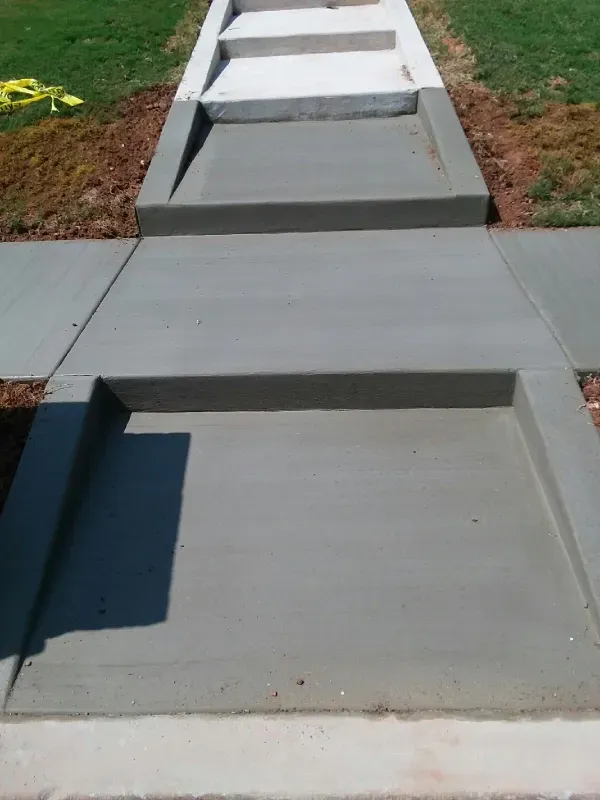 Concrete walkway with steps and inset areas.