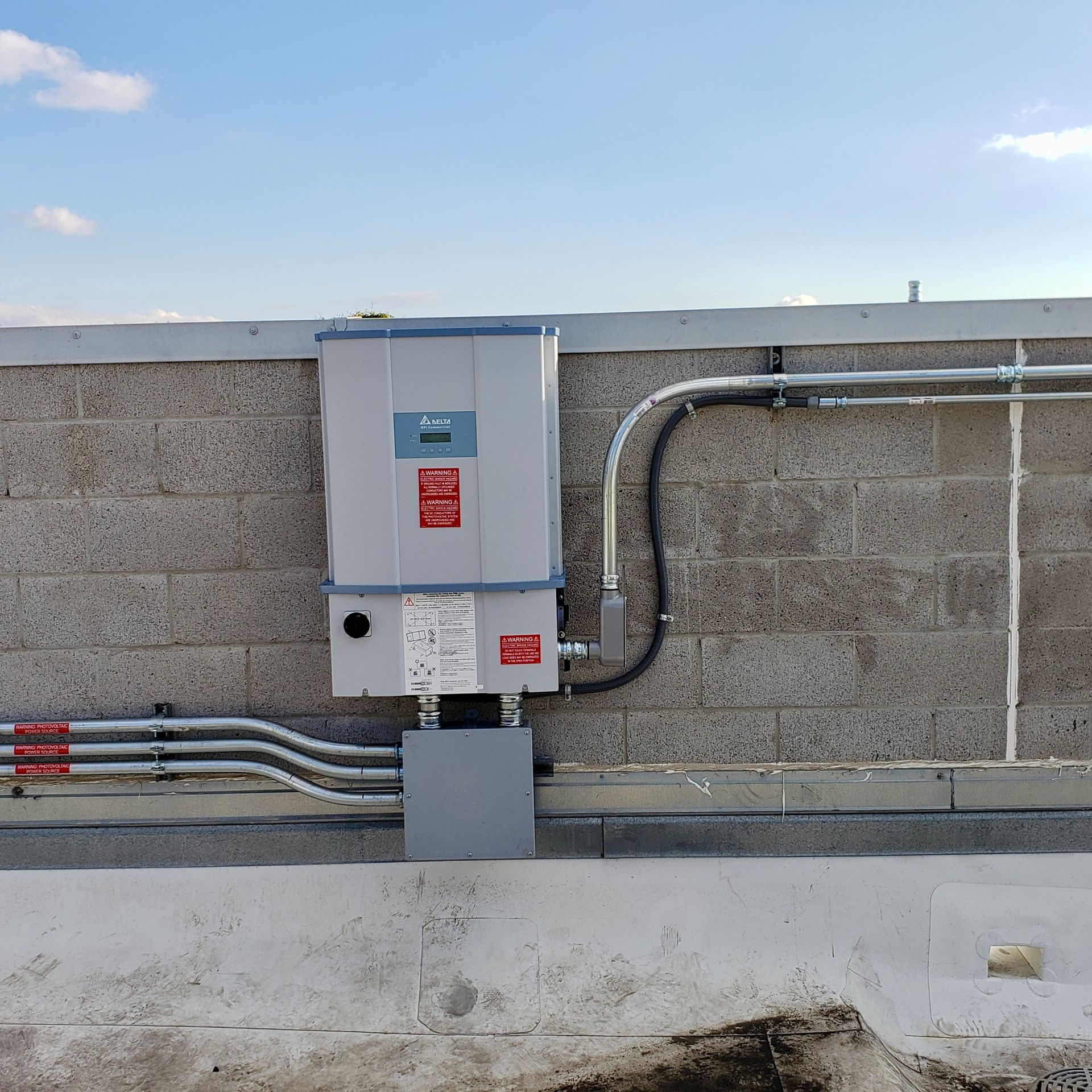 A brick wall with electrical wires coming out of it