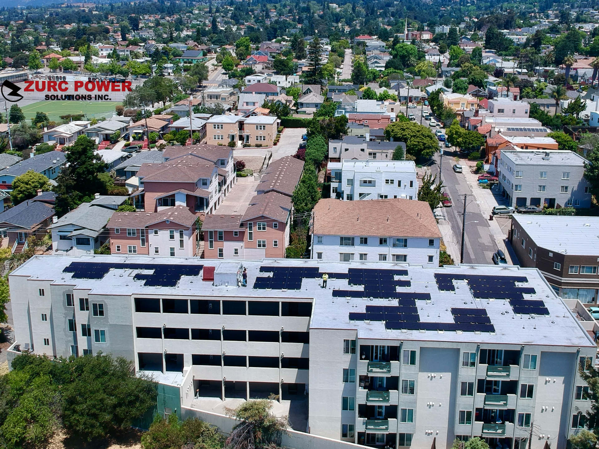 An aerial view of a building with solar panels on the roof