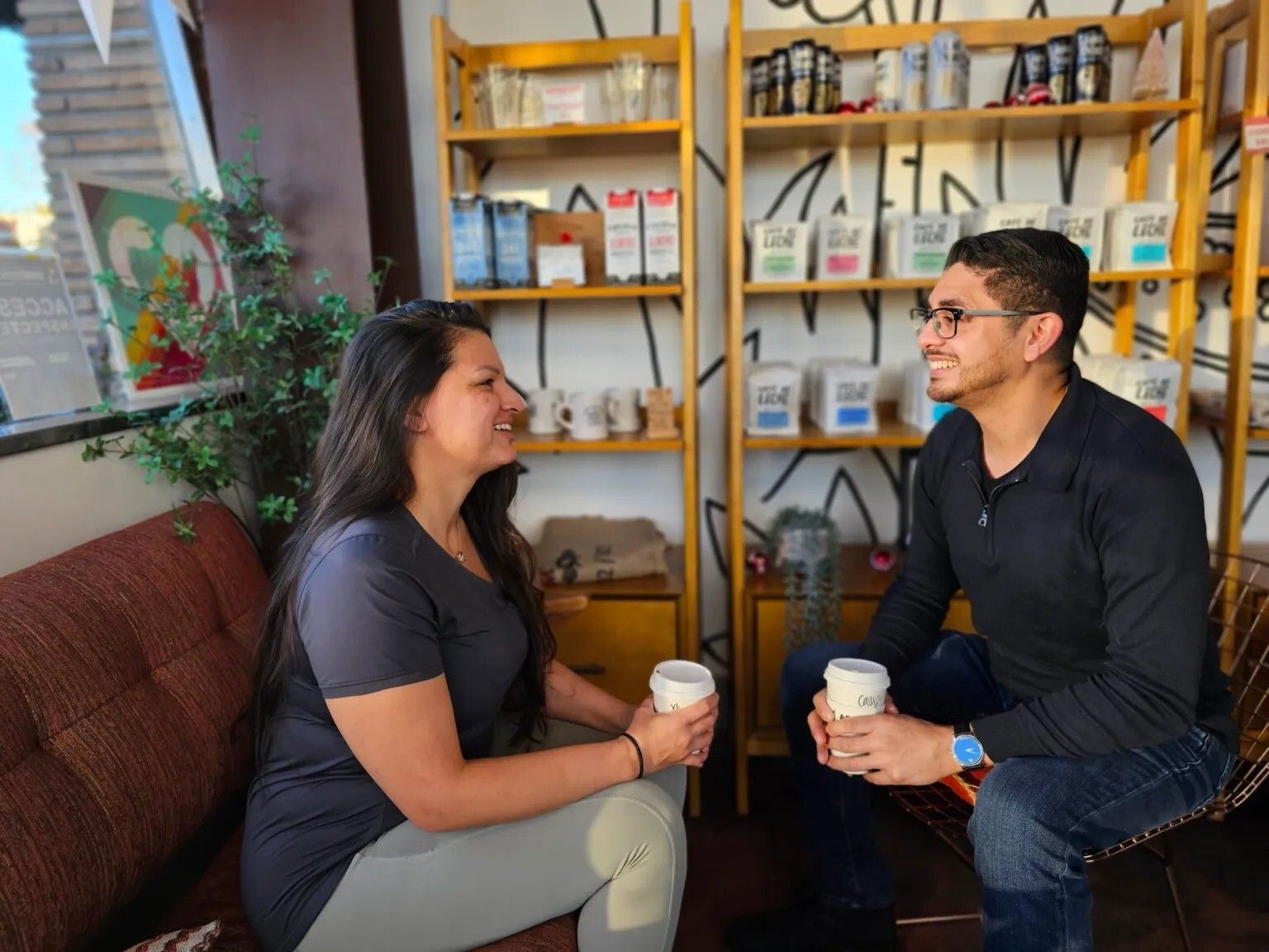 A woman is shaking hands with a man in an office.