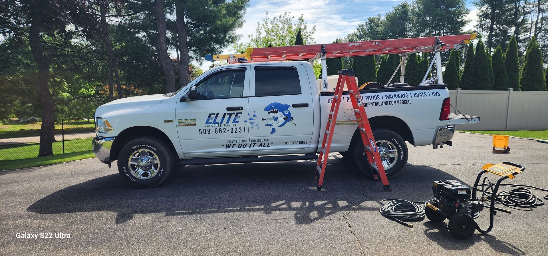 White pickup truck with ladder and equipment. 