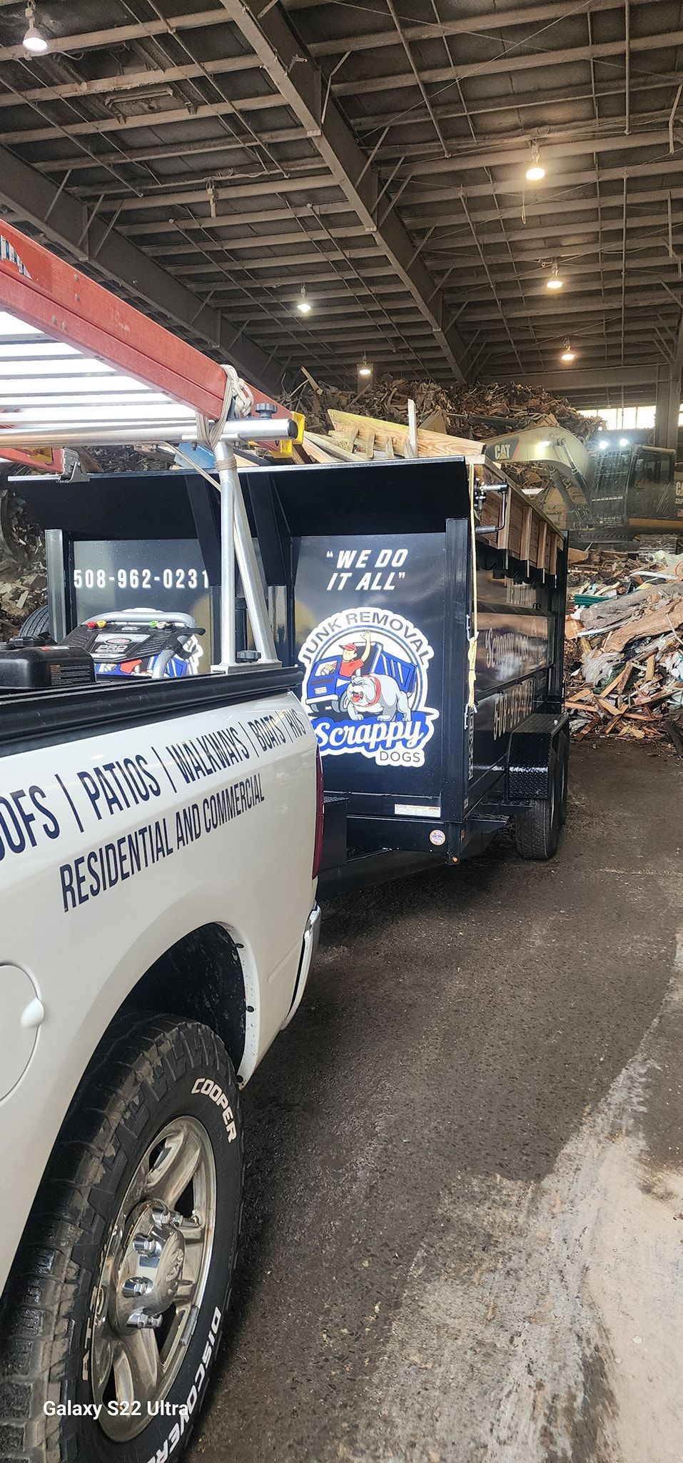 A white pickup truck towing a trailer with a black box. The box has a Star Wars graphic.