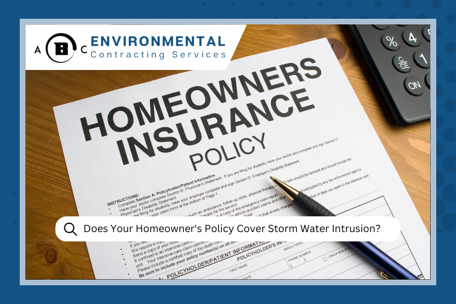 Homeowners insurance policy on a wooden table with a pen and calculator, discussing storm water intrusion coverage.