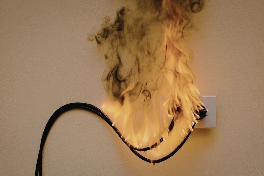 Electrical fire damage around a wall outlet in a home