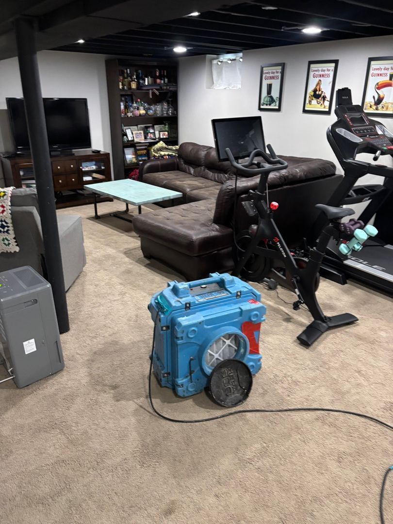 Air scrubber equipment in finished basement during mold remediation