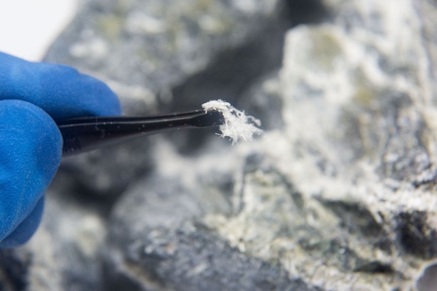 Close-up of asbestos material sample collection process