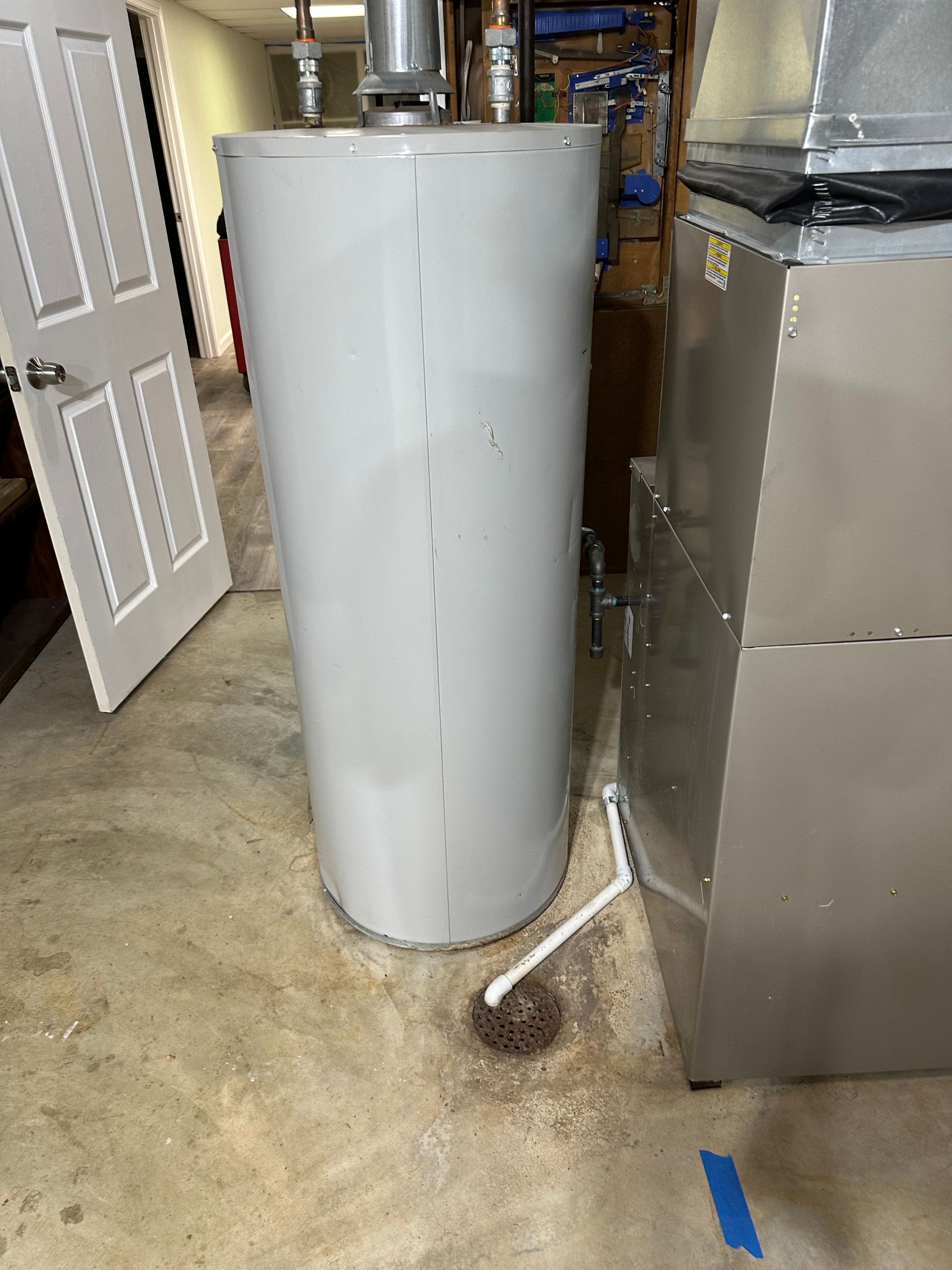 Burst pipe near water heater in basement utility room