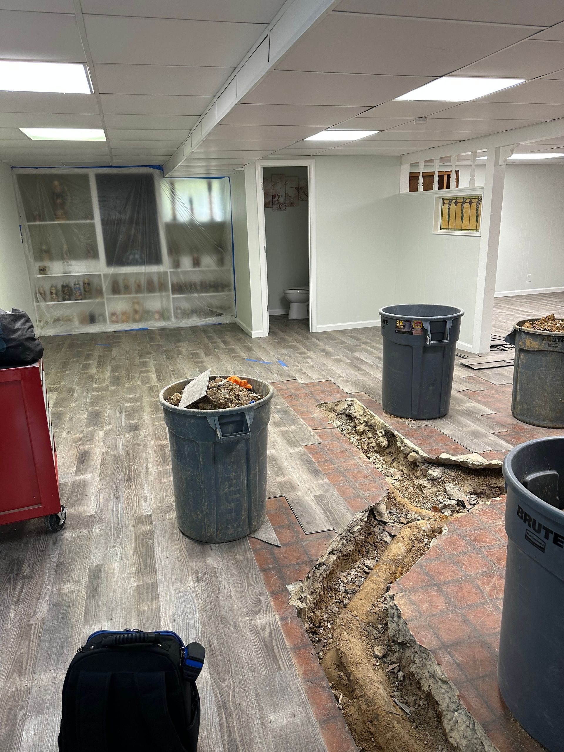 Floor trench demolition during basement water damage restoration