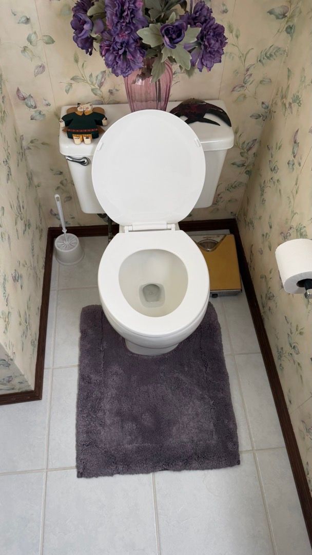 Water leak inspection inside bathroom sink cabinet showing moisture damage