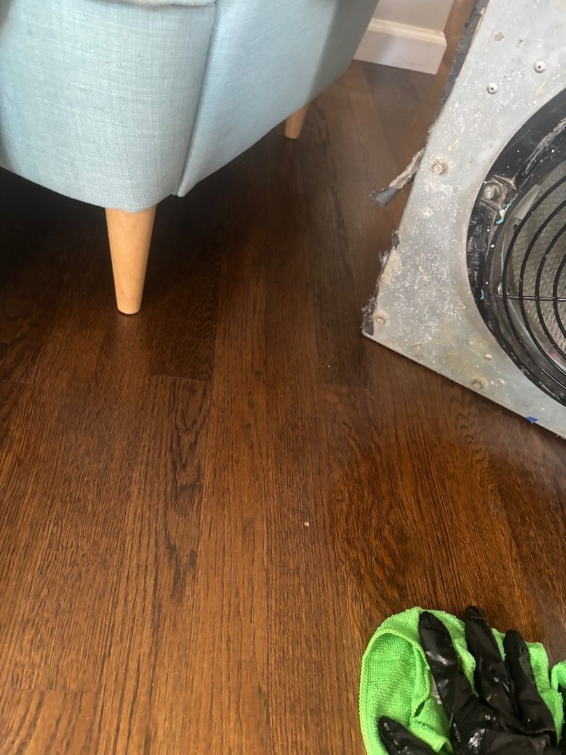 Cleaning around air scrubber on wood floor