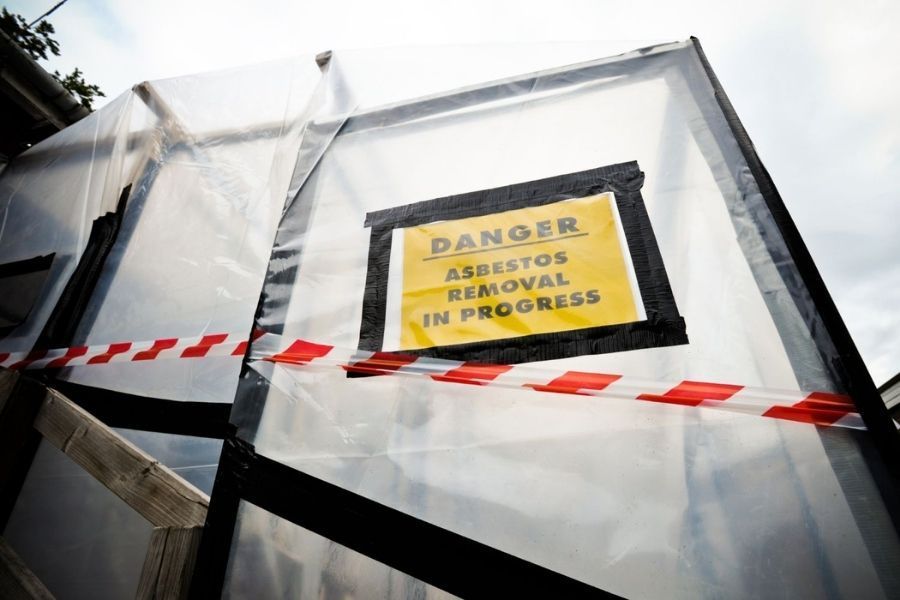 Danger asbestos removal containment area with warning signs