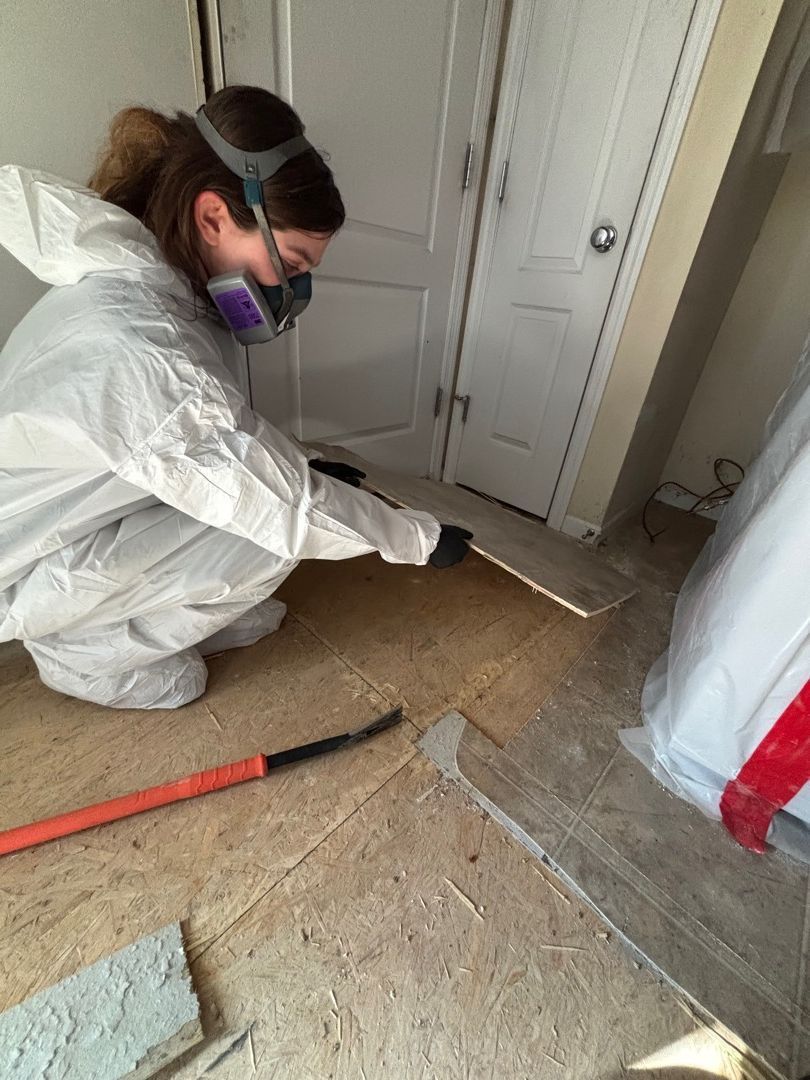 Fire-damaged flooring being removed during restoration cleanup in a St. Louis area home