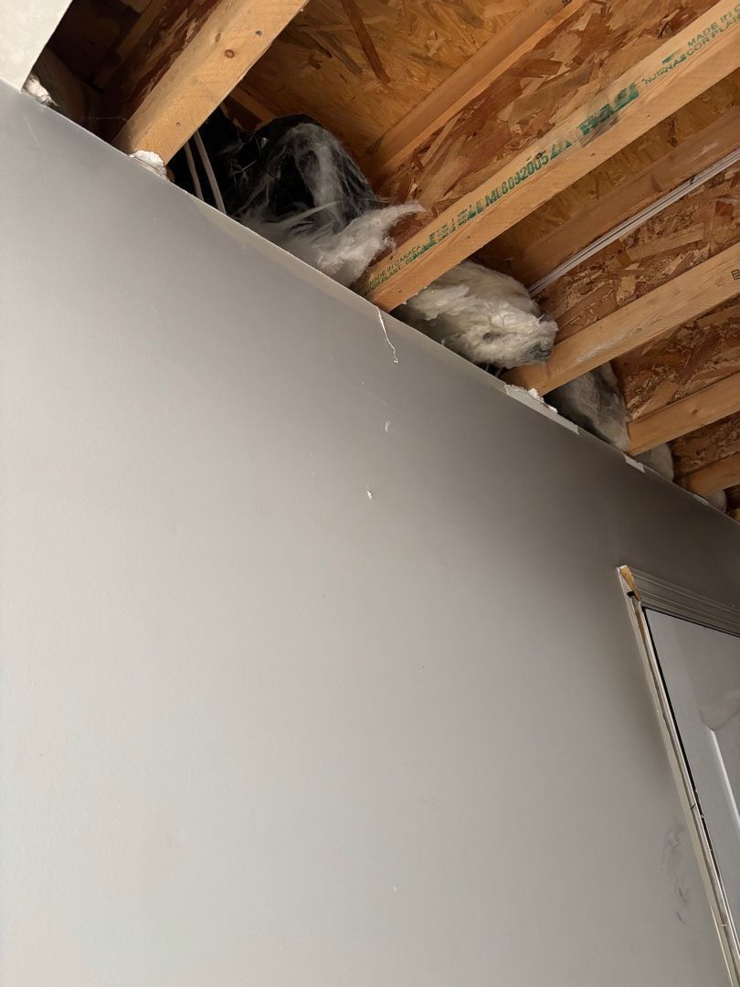 Exposed fire-damaged insulation during demolition work at a St. Louis area home