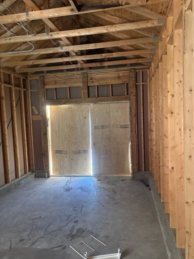 Room stripped down to bare studs after fire damage demolition in a St. Louis residential property