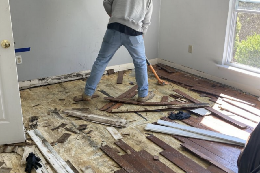 Water damaged flooring being removed during restoration