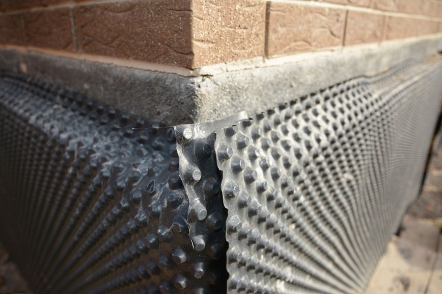 Dimple membrane waterproofing installation on foundation