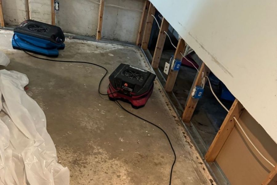 Restoration technician documenting mitigation progress for insurance records