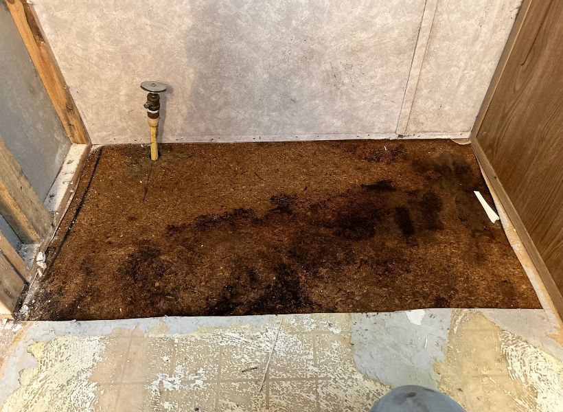 wet sub floor underneath fridge that was removed