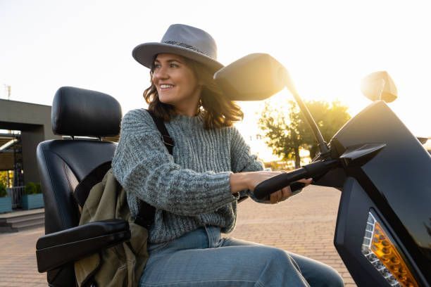 Woman riding a four-wheeled scooter, showcasing safe and reliable medical equipment.