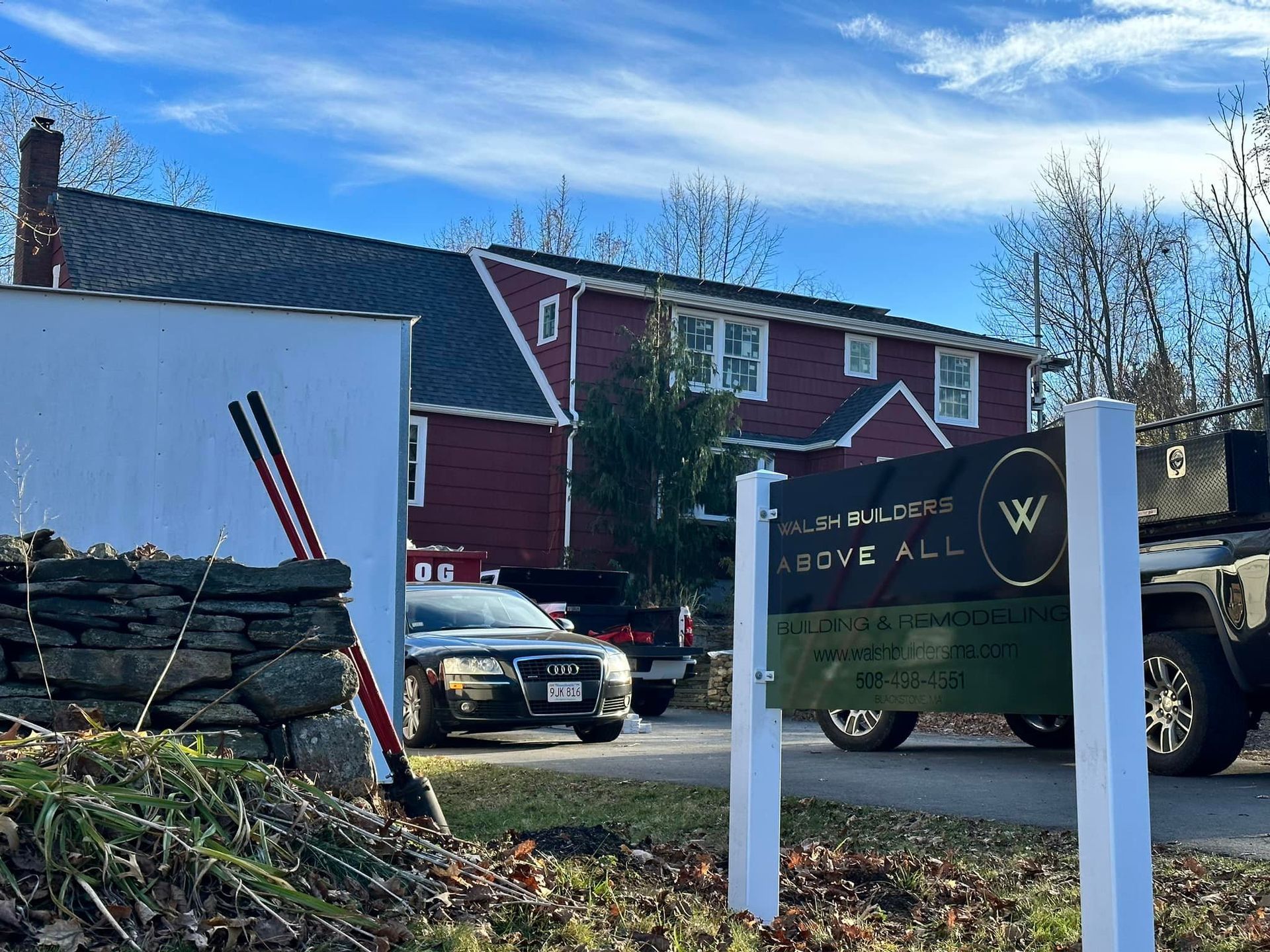 A red building with white trim, a sign that says