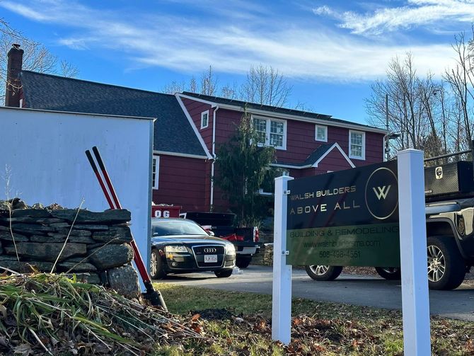 A red building with white trim, a sign that says