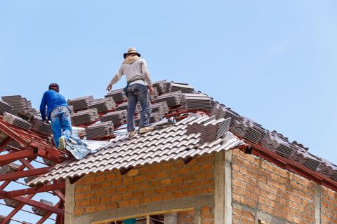 Roofers working on a house