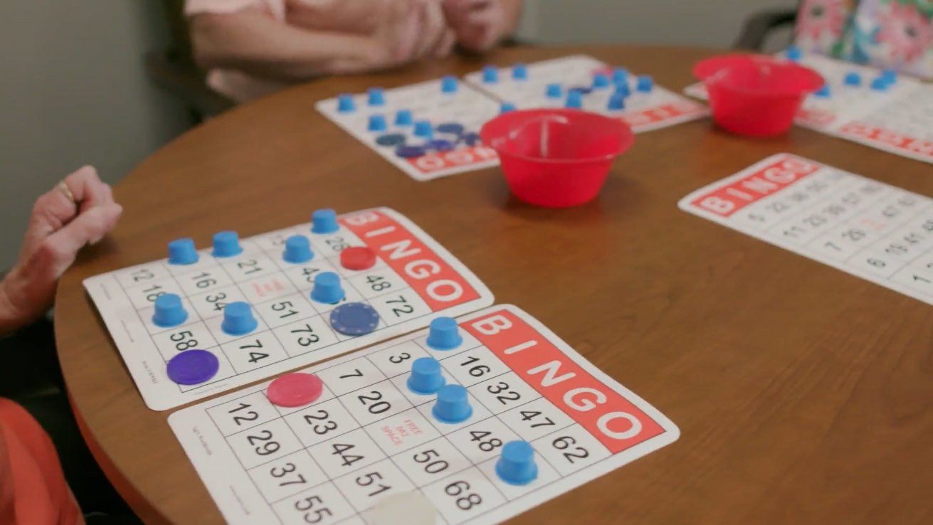 A group of people are playing bingo at a table.