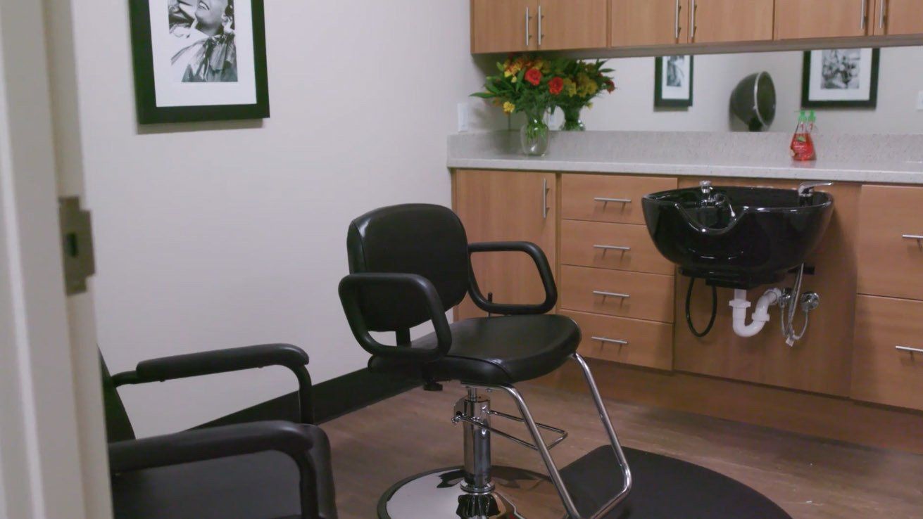 A room with a chair and a sink in it