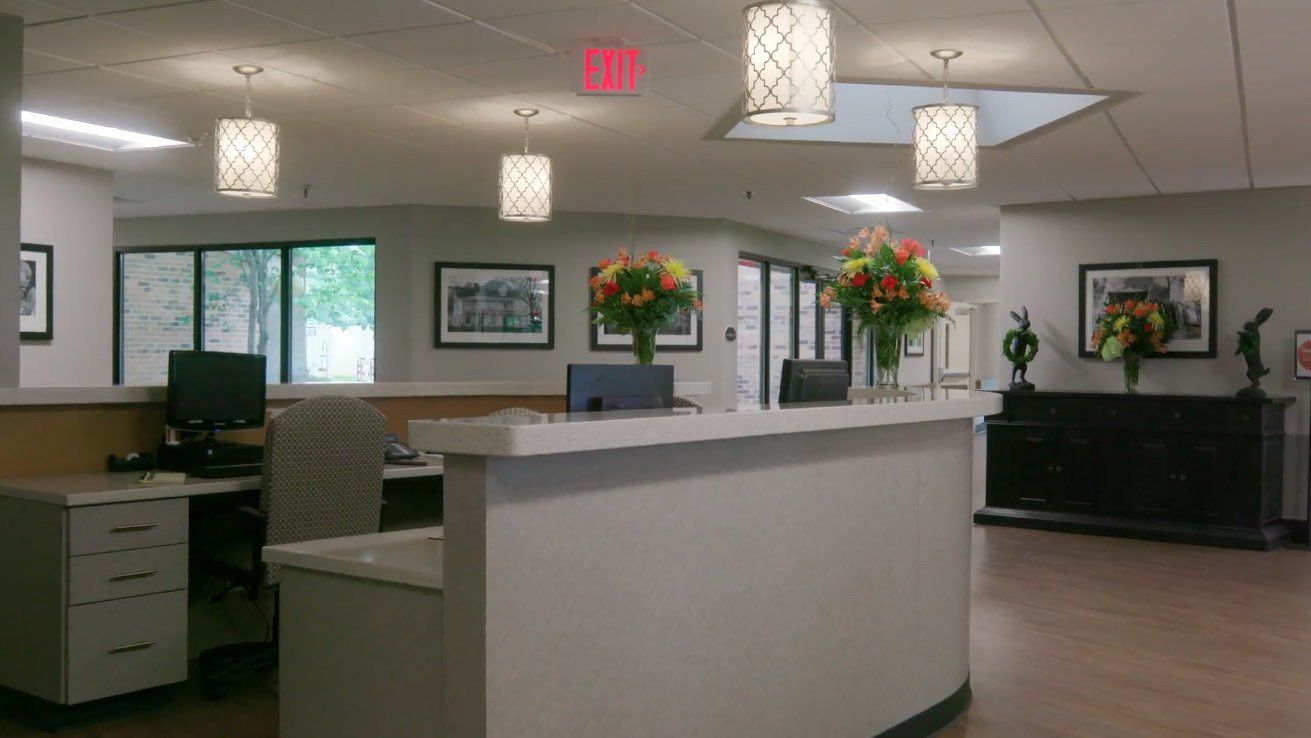 A reception desk in a hospital with flowers on it