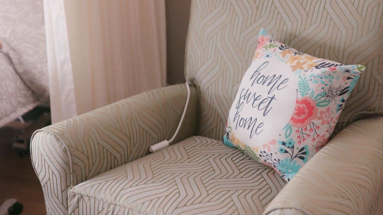 A chair with a pillow on it that says `` home sweet home ''.
