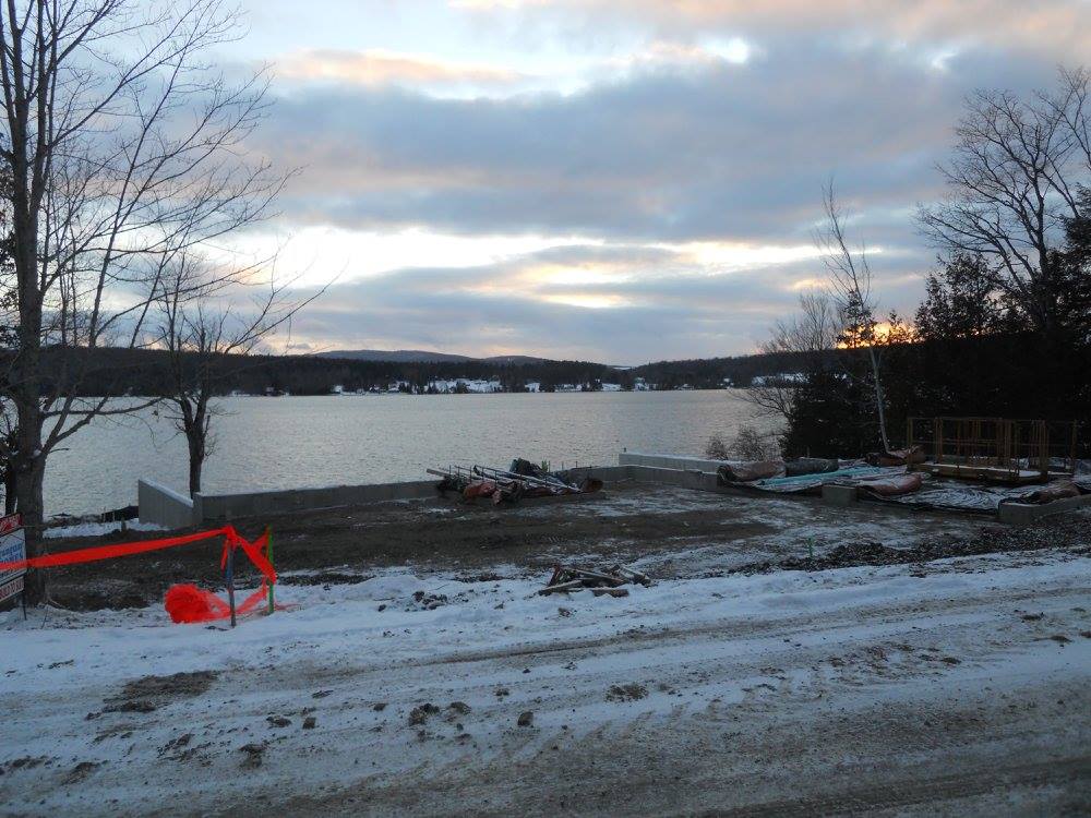 A snowy area with a large body of water in the background