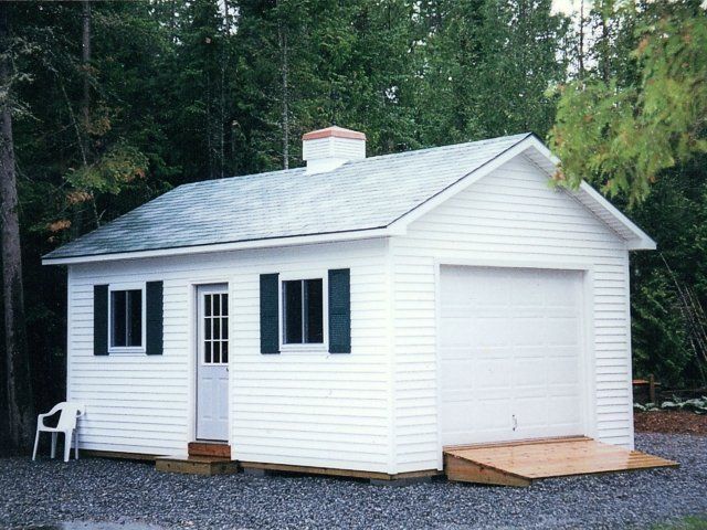 A small white house with black shutters on the windows