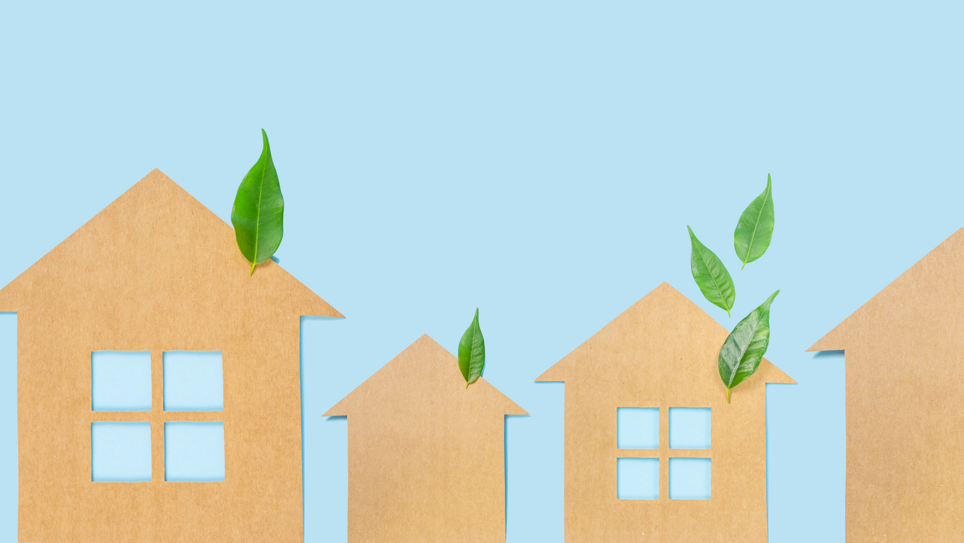 A row of wooden houses with green leaves on top of them on a blue background.