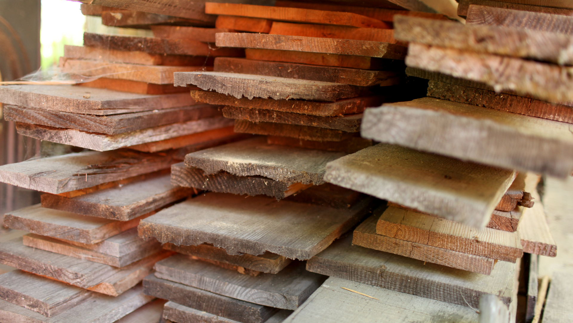 Planks of reclaimed lumber stacked on top of each other