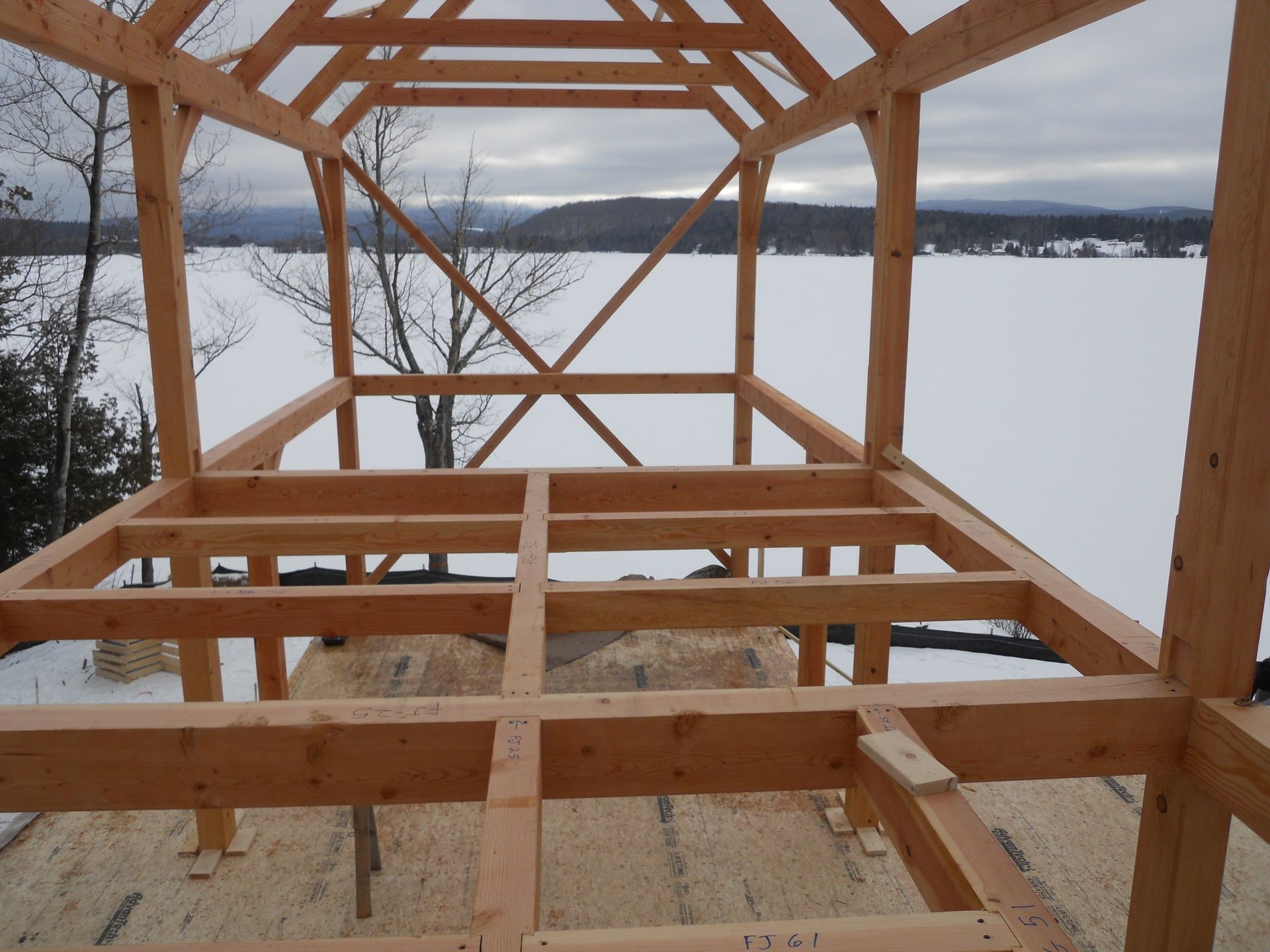 A wooden structure is being built in the snow