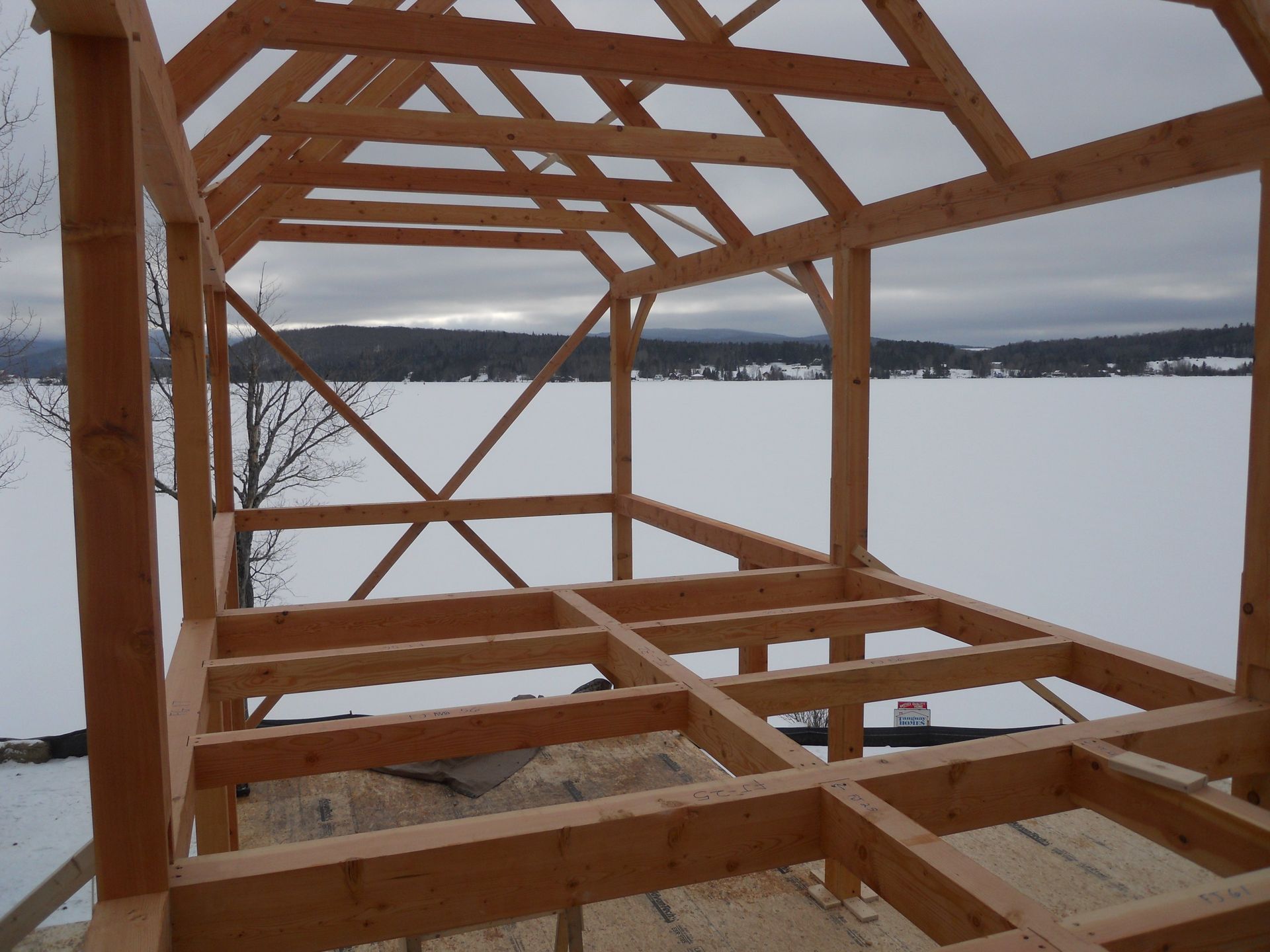 A wooden structure is being built in the snow